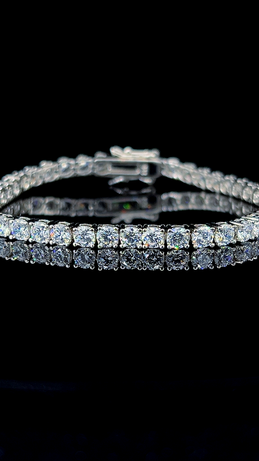 Classic 925 sterling silver tennis bracelet featuring round brilliant cubic zirconia stones on a dark reflective surface.