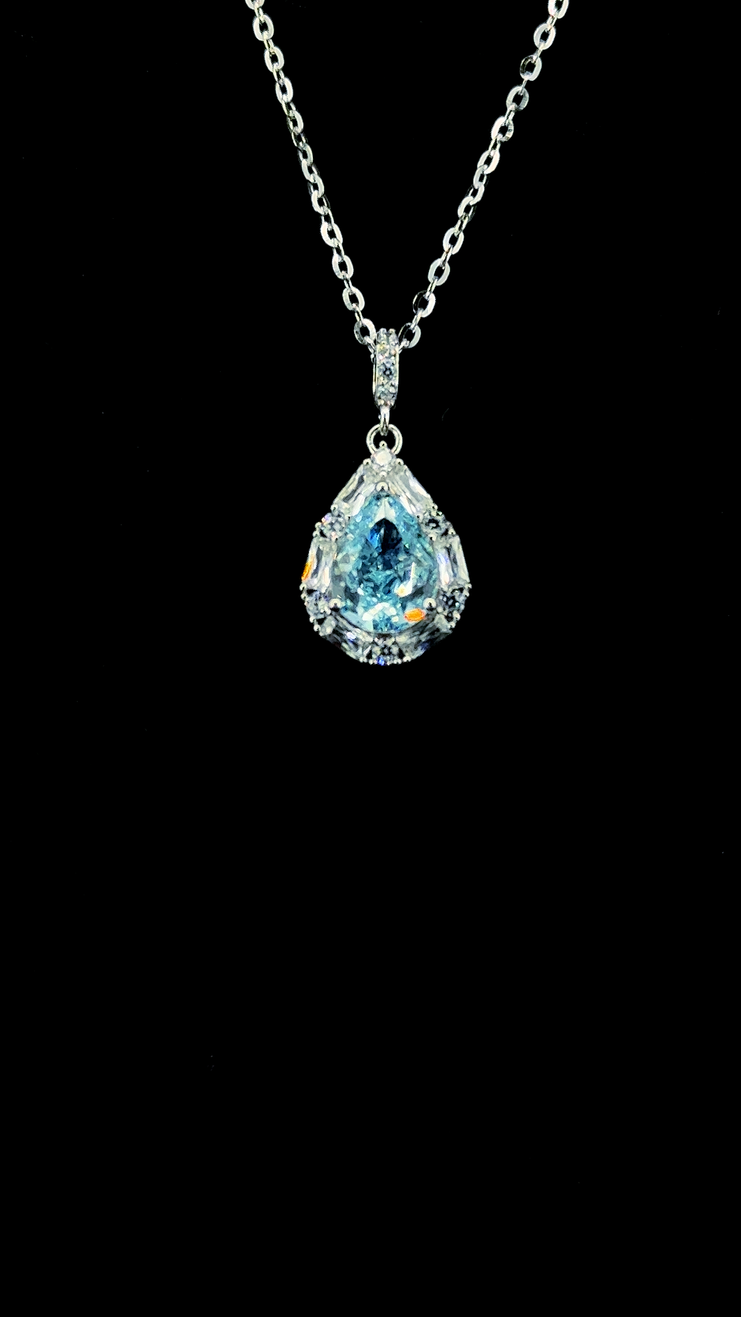 Large blue pear-shaped Cubic Zirconia teardrop pendant chain with white CZ baguette halo in BIS Hallmarked 925 sterling silver — The Azure Drop by The White Kala