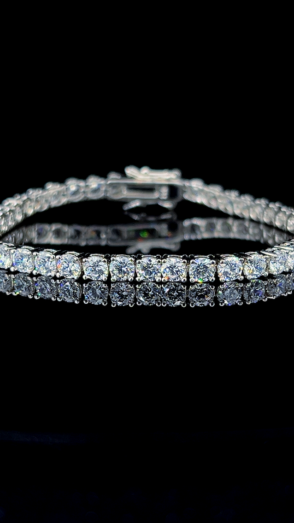 Classic 925 sterling silver tennis bracelet featuring round brilliant cubic zirconia stones on a dark reflective surface.