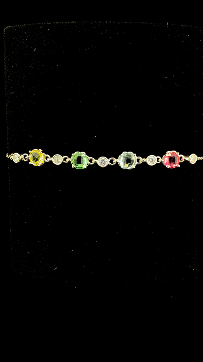 Delicate 925 sterling silver chain bracelet featuring multi-colored and clear cubic zirconia stones against a dark background.